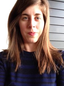 Woman with long brown hair in dark top